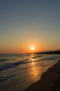 Scenic view of beach against sky during sunset