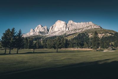 Scenic view of snowcapped mountains against clear blue sky