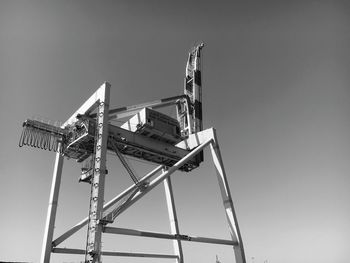 Low angle view of crane against clear sky