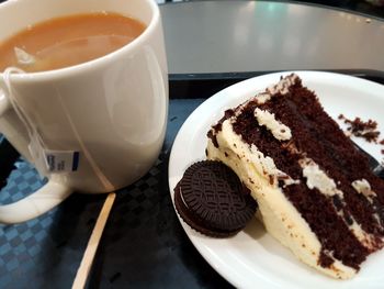 Close-up of chocolate cake with coffee served on table