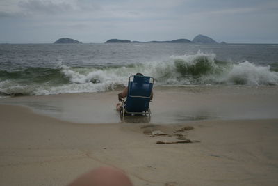 Lifeguard hut on beach against sky