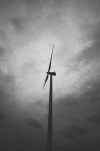 Low angle view of weather vane against sky