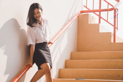 Young woman on staircase at home