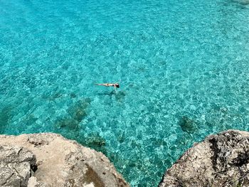 High angle view of woman swimming in sea