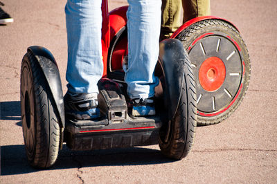 Low section of man standing on segway at street