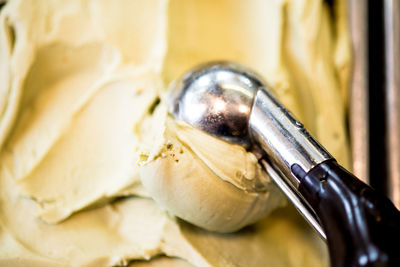 Close-up of serving scoop on ice cream in container