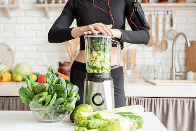 Midsection of woman preparing food in kitchen