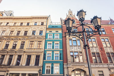 Poland, lower silesian voivodeship, wroclaw, street light in front of row of historic houses