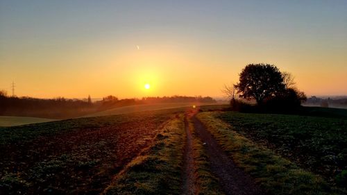 Scenic view of field against sky during sunset