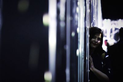 Side view of young man looking at camera