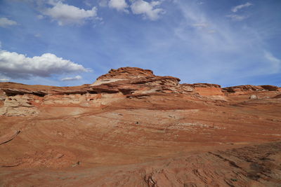 Low angle view of sand dunes against sky