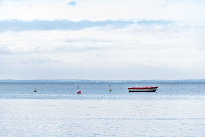 Boat sailing on sea against sky