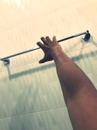 High angle view of person hand on tiled floor