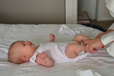 Cute baby sleeping on bed at home