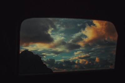 View of storm clouds over window