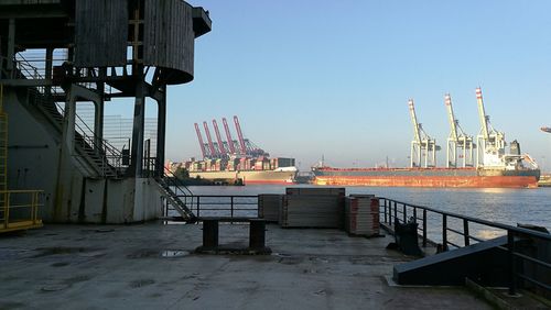 Boats in sea against clear sky