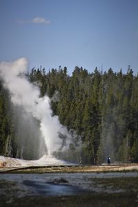 Scenic view of waterfall against sky