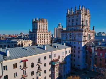 Buildings in city against blue sky
