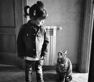 Child and tabby cat indoors