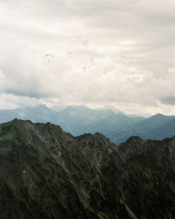 Scenic view of paragliders in the mountains near oberstdorf. shot on 35mm kodak portra 800 film.