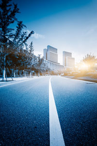 Empty road against blue sky