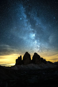 Scenic view of rock formation against sky at night