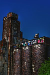 Low angle view of built structure against clear blue sky