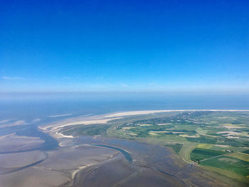 Aerial view of landscape and sea against sky