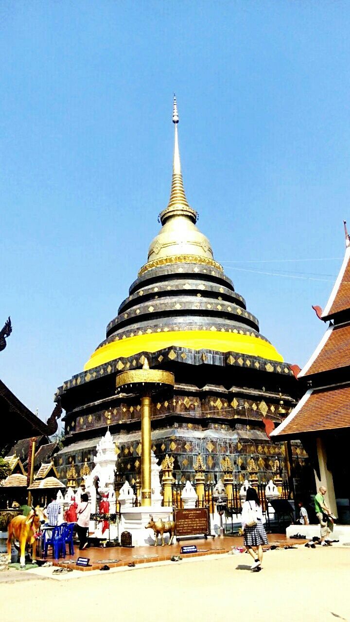 clear sky, architecture, built structure, building exterior, blue, religion, place of worship, low angle view, spirituality, copy space, travel destinations, temple - building, famous place, sunlight, tourism, incidental people, travel, day