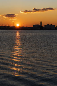 Sunset from the audace pier of trieste. colors of fire on the water. italy