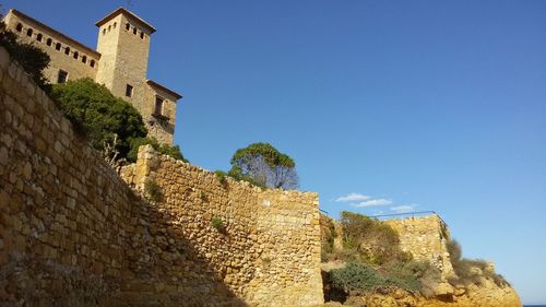 Low angle view of building against blue sky