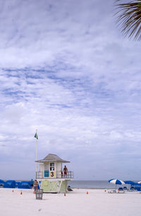 Scenic view of beach and buildings against sky