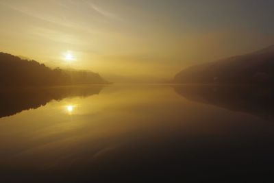 Scenic view of lake against sky during sunset