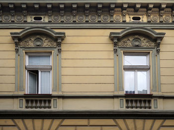 Two windows with ornaments on old building