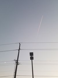 Low angle view of electricity pylon against sky