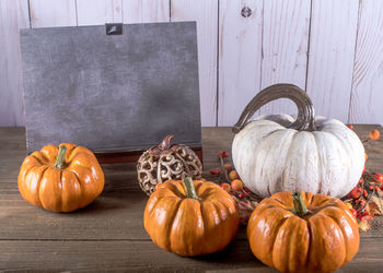 Pumpkins on wooden table during autumn