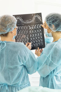 Female dentists examining x-ray at clinic