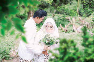 Young couple standing on field