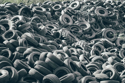 Landfill of old car tires torn spoiled abandoned.