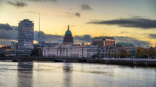 Buildings in city at sunset