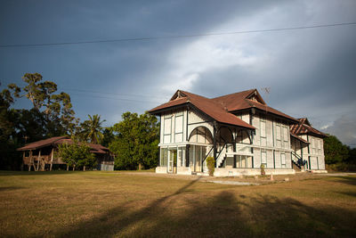 House on field against sky