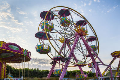 Low angle view of ferris wheel against sky