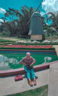 Rear view of boy in swimming pool against trees