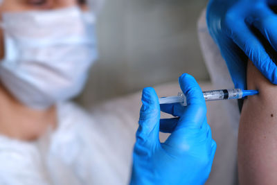 Midsection of dentist examining patient in hospital