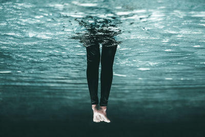 Low section of woman swimming in sea