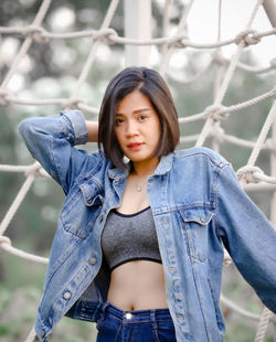 Woman standing by rope at park