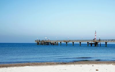 Pier over sea against clear sky