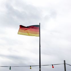 Low angle view of flag against sky