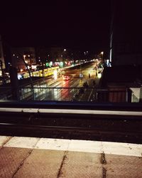 Illuminated road in city at night