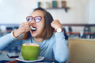 Young woman sitting at table